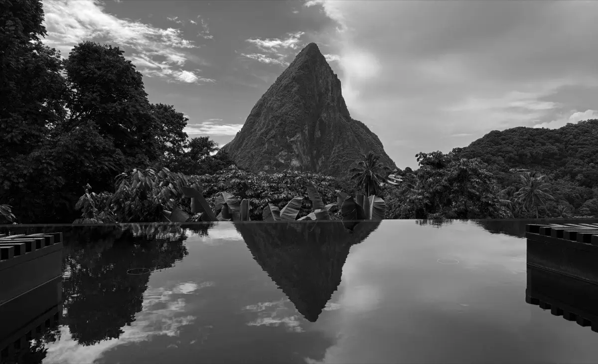A Piton peak reflected in an infinity pool, in black and white