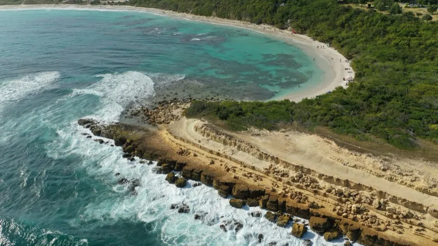 Surf breaking around a rocky point