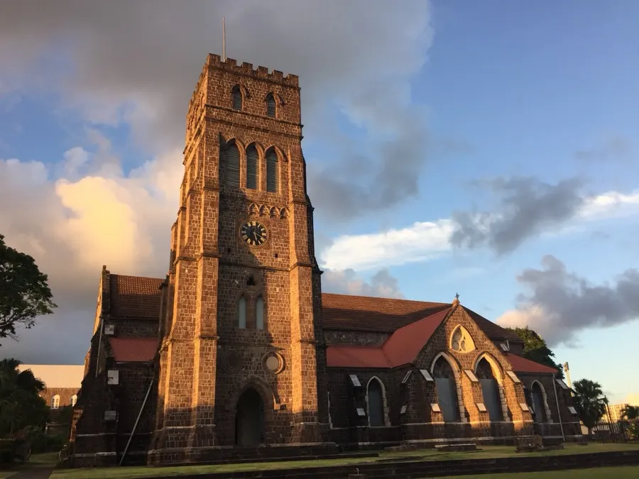 A stone church tower at sunset