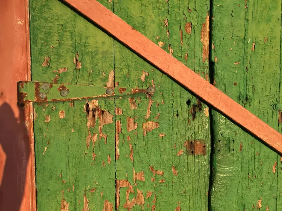 A peeling green door