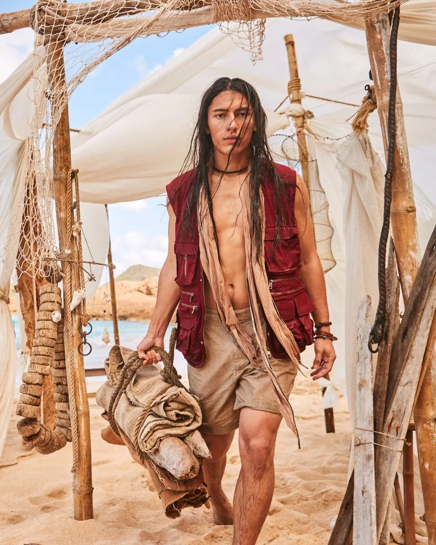 Model walking out of a beach tent