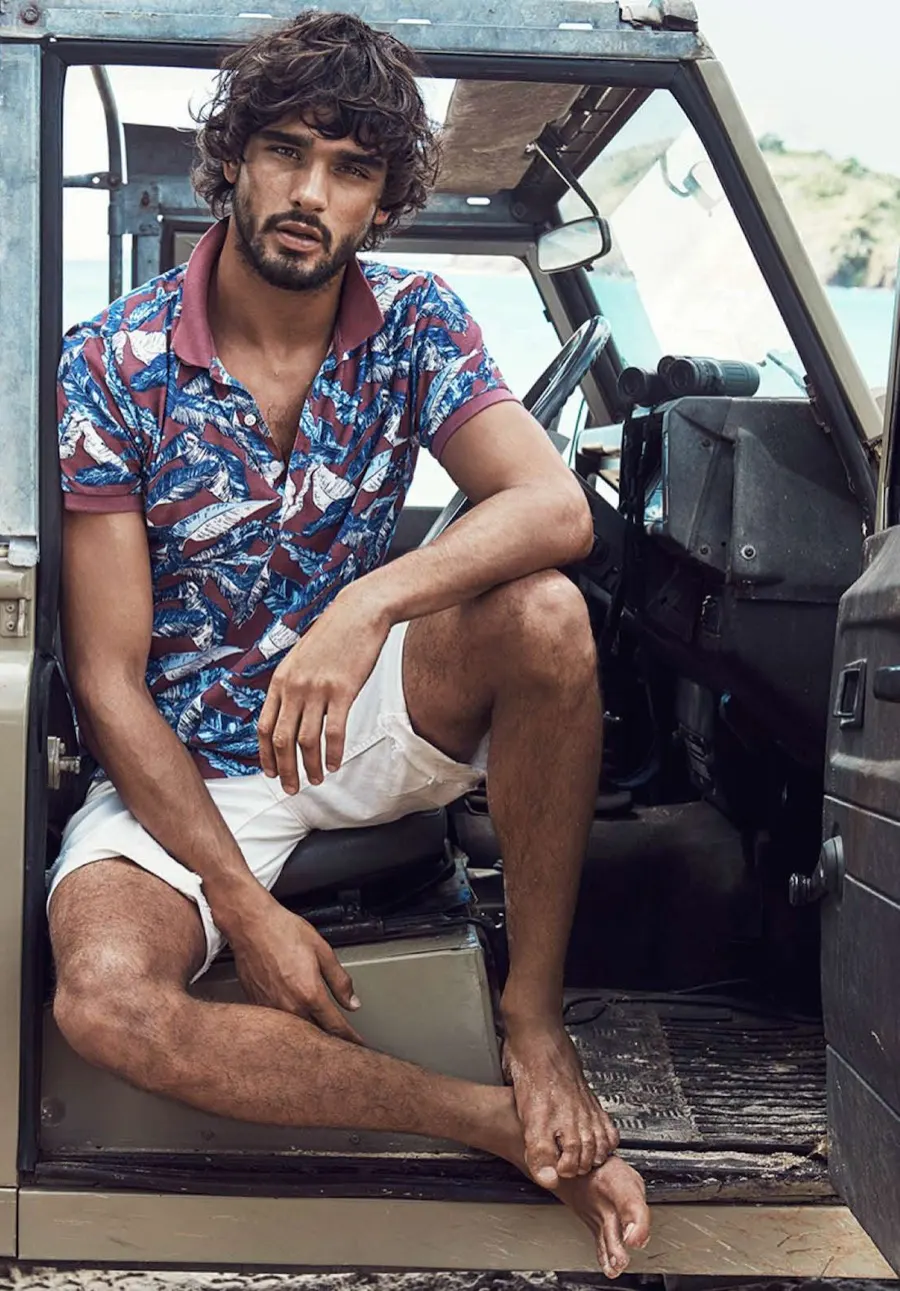Model sitting in an open Land Rover